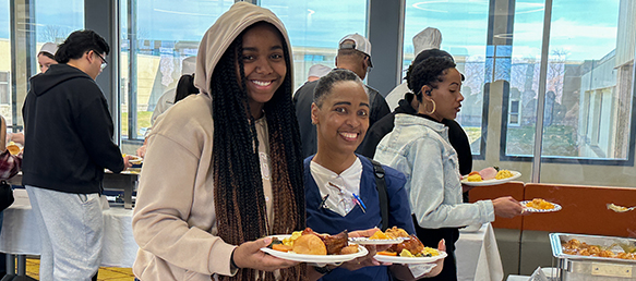 Two women smiling at the camera at the Soul Food Luncheon